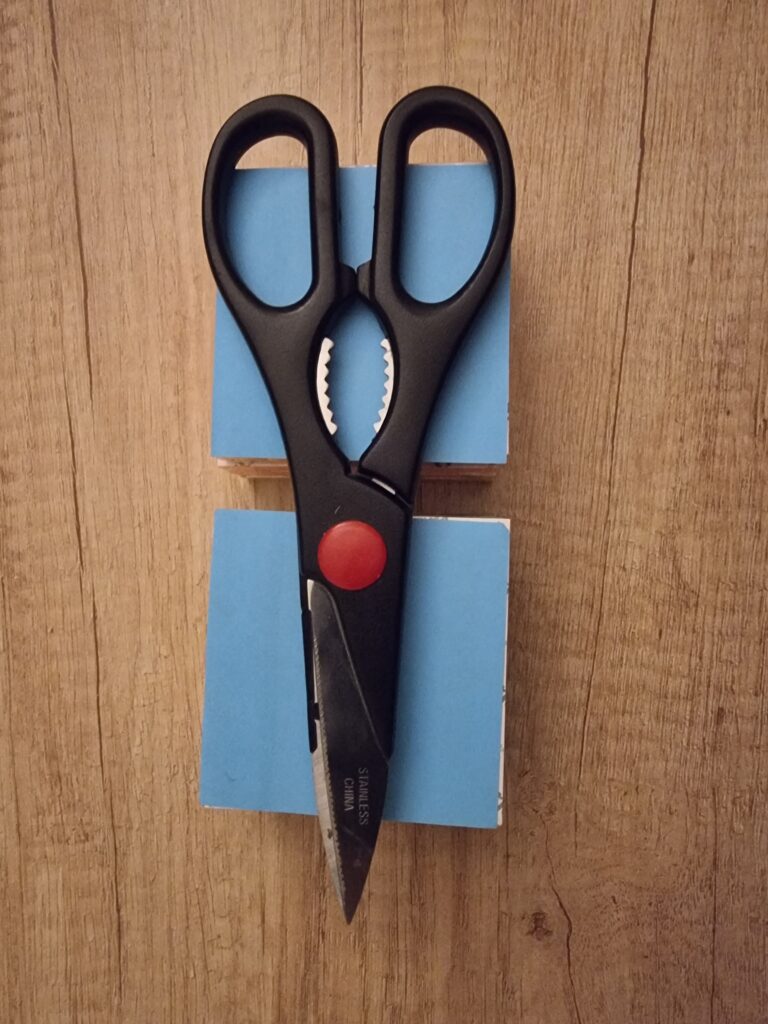 A pair of scissors and two blocks of sticky notes.
Its all a matter of perspective.